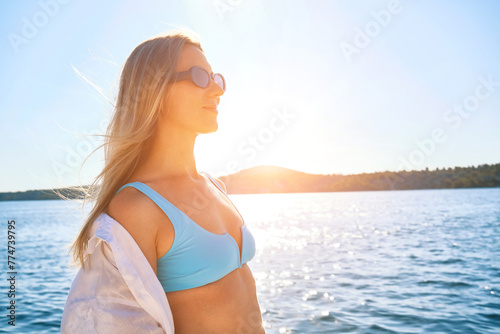 Fashionable beautiful woman relaxing outdoors on the beach