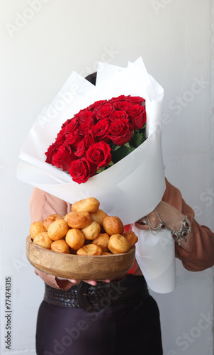 Baursaks and bouquet of red roses