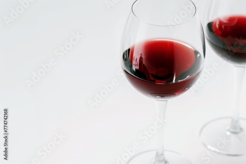 red wine in clear wine glass on white background copy space