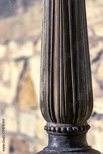 Decorative part of the column. A column with pronounced grooves. Decorative iron element © Janiel Kaffe
