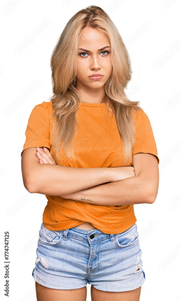 Young blonde girl wearing casual clothes skeptic and nervous, disapproving expression on face with crossed arms. negative person. Young blonde girl wearing casual clothes skeptic and nervous, disapproving expression on face with crossed arms. negative person.