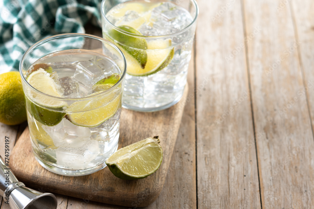 Glass of vodka tonic cocktail on wooden table Glass of vodka tonic cocktail on wooden table