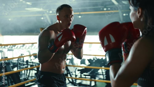 A dedicated female boxer trains under the watchful eye of her experienced coach, focusing on mastering the art of boxing with precise technical skills. Camera 8K RAW. 