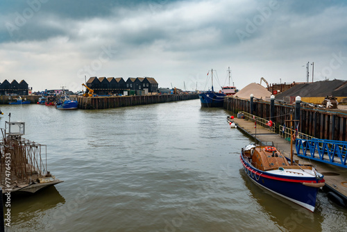 Whitstable harbour with black fishing huts in Kent