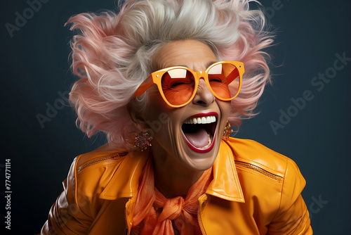 Happy funny senior woman in orange sunglasses
