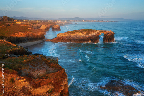 Aerial view of the Cathedrals beach (Playa de las Catedrales) or Praia de Augas Santas at sunrise, amazing landscape with rocks and Atlantic Ocean, Ribadeo, Galicia, Spain. Outdoor travel background photo