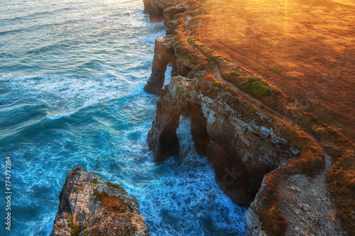 Aerial view of the Cathedrals beach (Playa de las Catedrales) or Praia de Augas Santas at sunrise, amazing landscape with rocks and Atlantic Ocean, Ribadeo, Galicia, Spain. Outdoor travel background photo