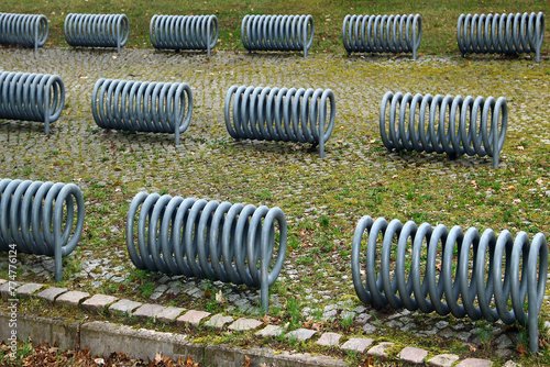 Metal spirals of empty bike stands on a bicycle parking lot