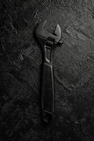 Spanner on a black stone background. Concept of repair or adjustment.