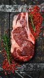 Raw steak. Beef steak with seasonings on a wooden board, close-up.