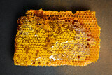 Background made of wax honeycomb filled with organic honey. Macro photo.