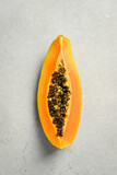 Close up of exotic papaya fruit. Sliced papaya on a gray concrete background.