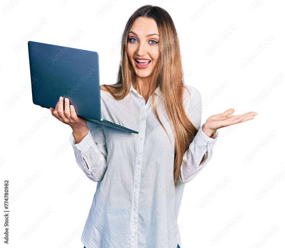 Beautiful caucasian woman working using computer laptop celebrating achievement with happy smile and winner expression with raised hand Beautiful caucasian woman working using computer laptop celebrating achievement with happy smile and winner expression with raised hand