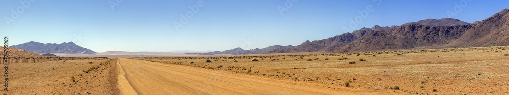 Picture of a gravel road on the edge of the Namib Naukluft National Park in Namibia against a blue sky