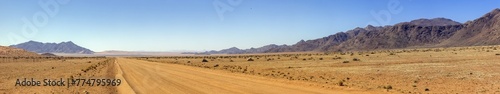 Picture of a gravel road on the edge of the Namib Naukluft National Park in Namibia against a blue sky