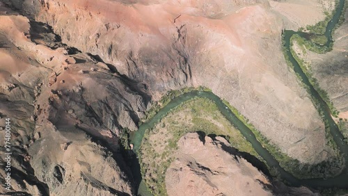 Charyn Canyon, Kazakhstan. Aerial drone view of Sharyn National Park. High altitude shot panning up from canyon river to red mountains. Famous travel landmark destination in Qazaqstan, Central Asia