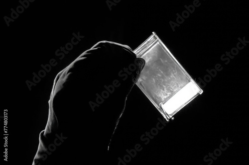 Man's fingers is holding a white synthetic drug narcotic. Synthetic drugs narcotics narcotic and psychotropic drugs concept photo