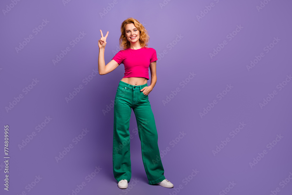 Photo of lovely adorable woman dressed trendy bright clothes hand showing v-sign isolated on purple color background - obrazy, fototapety, plakaty 