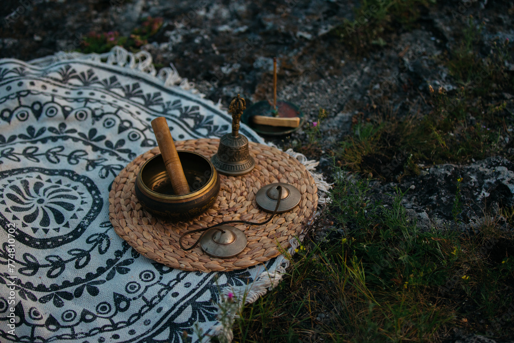Singing bowl, Tingsha and Gantha Buddhist bell, sunset meditation.