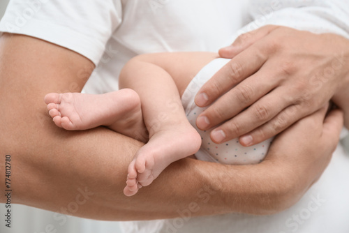 Father holding his cute baby, closeup view