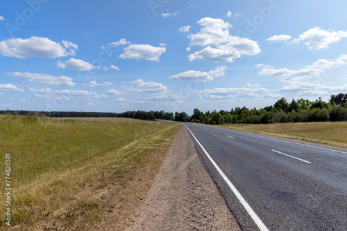 paved road along and blue sky