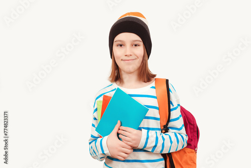 Cute teenager with school backpack. Back to school. Boy in casual clothes with books for studing.