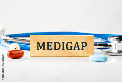 Medical concept. MEDIGAP on a wooden block on a gray background