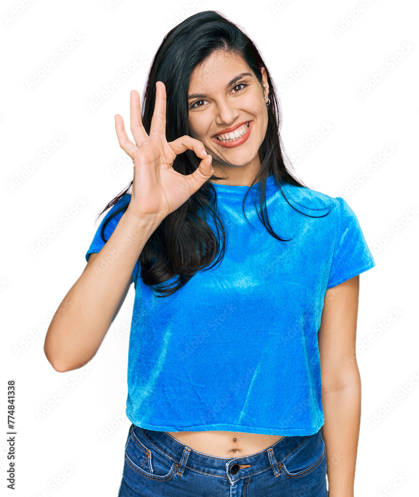 Young hispanic woman wearing casual clothes smiling positive doing ok sign with hand and fingers. successful expression. Young hispanic woman wearing casual clothes smiling positive doing ok sign with hand and fingers. successful expression.