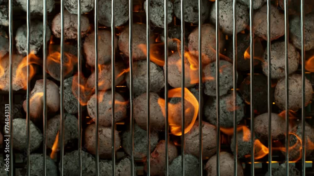 Super slow motion of burning charcoal on grill grid. Filmed on high speed cinema camera, 1000 fps. Top view.
