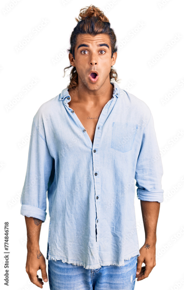 Young hispanic man wearing summer style afraid and shocked with surprise and amazed expression, fear and excited face.