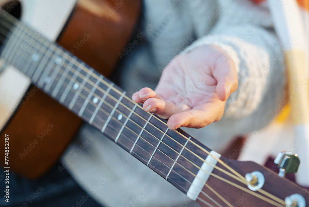 Girl shows callus on her fingers after playing the guitar for a long ...