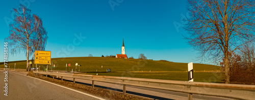Alpine winter view with a church near Rieden, Bavaria, Germany photo