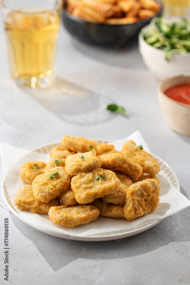 There is a plate of crispy chicken nuggets on the table. Fast food, fast food restaurant. There is a plate of crispy chicken nuggets on the table. Fast food, fast food restaurant.