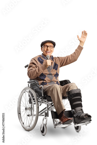 Cheerful elderly man with a broken leg in a wheelchair singing