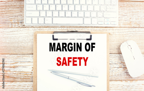 MARGIN OF SAFETY text on clipboard with keyboard