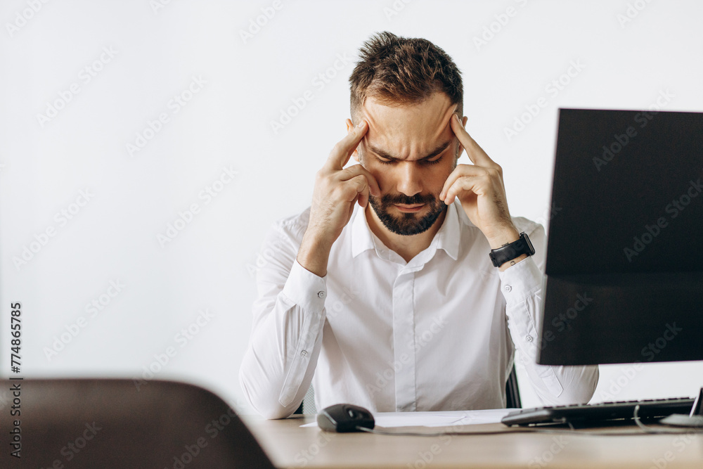 Business man having headache at work place Business man having headache at work place