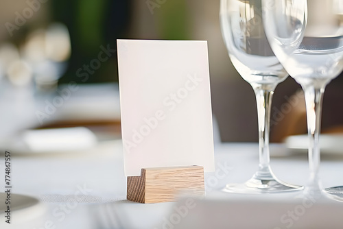 Wedding white blank table number mockup. Table number template standing on the table with floarl decor. photo