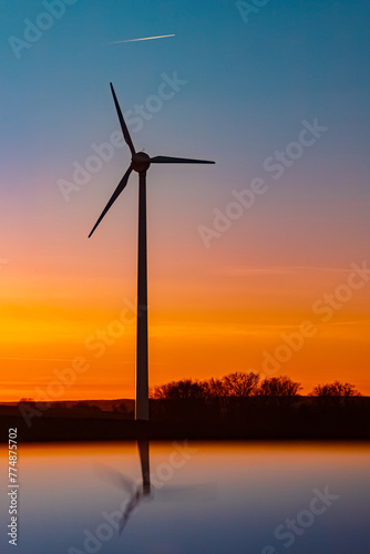 Sunset with wind turbine silhouettes and reflections on a car roof near Kugl, Simbach bei Landau, Dingolfing-Landau, Bavaria, Germany photo