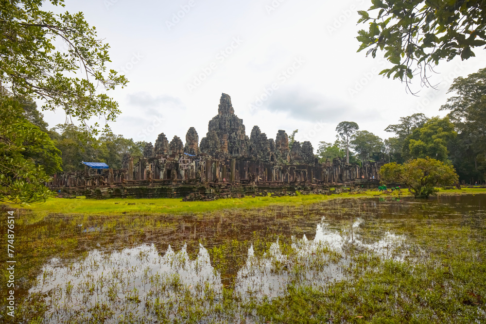 Ancient stone faces at sunset of Bayon temple, Angkor Wat, Siem reap, Cambodia.