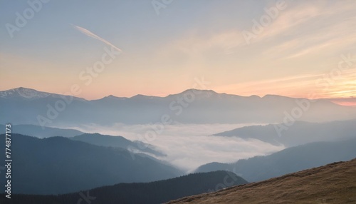 peaceful blue nature background with foggy bucegi mountains in carpathians seen from cota 2000 sinaia resort romania