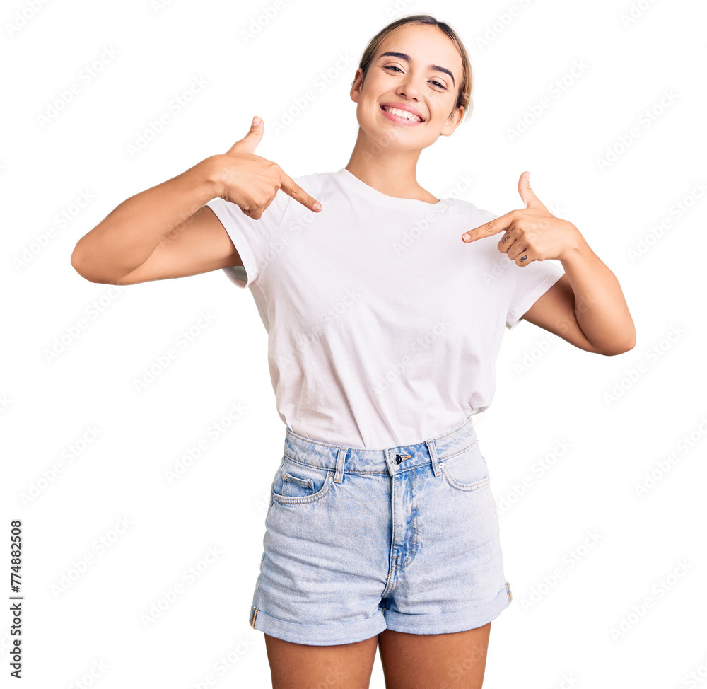 Young beautiful blonde woman wearing casual white tshirt looking confident with smile on face, pointing oneself with fingers proud and happy. Young beautiful blonde woman wearing casual white tshirt looking confident with smile on face, pointing oneself with fingers proud and happy.