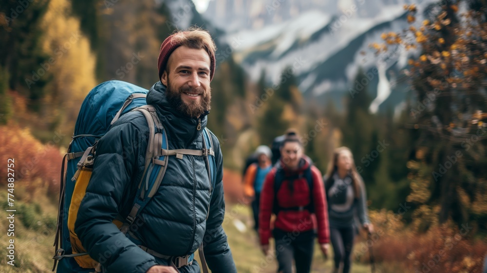 Bearded hiker leading friends in autumn