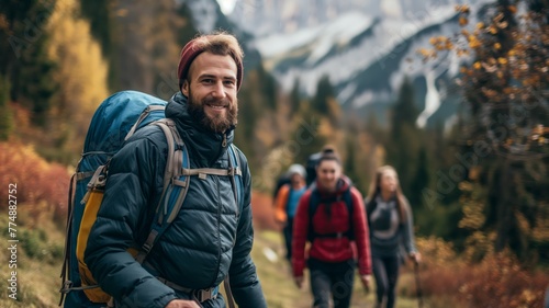 Bearded hiker leading friends in autumn © grape_vein
