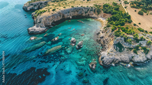 Serene Aerial View of a Mediterranean Cove with Crystal Clear Waters and Rugged Cliff Landscape