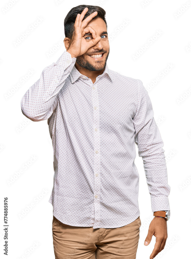 Handsome hispanic man wearing business clothes smiling happy doing ok sign with hand on eye looking through fingers