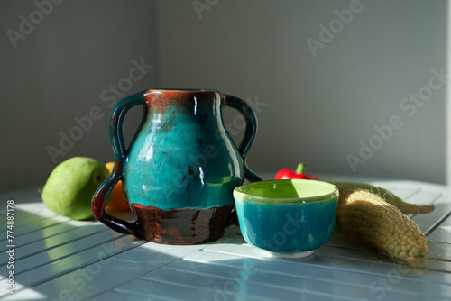 Still life with corn, pear, pepper and an old ceramic jug. Healthy eating concept. High quality photo
