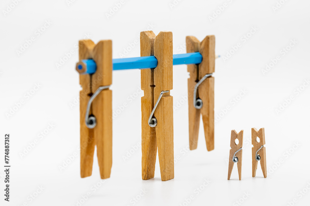 Pinzas de madera de la ropa de diferentes tamaños con un lápiz de color azul Pinzas de madera de la ropa de diferentes tamaños con un lápiz de color azul