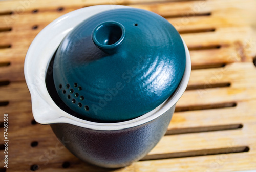 Chinesee teapot on tea board photo
