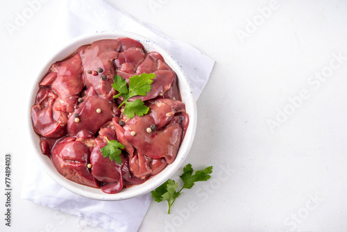 Raw chicken, turkey, duck, poultry liver with herbs and spices. Poultry liver dinner cooking background, diet food copy space