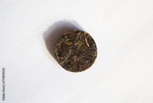 Sheng Puer pressed into a circle on a white background photo